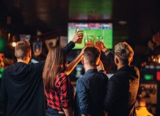 Pro Football Schedule November 2022 Friends Watches Football On Tv In A Sport Bar