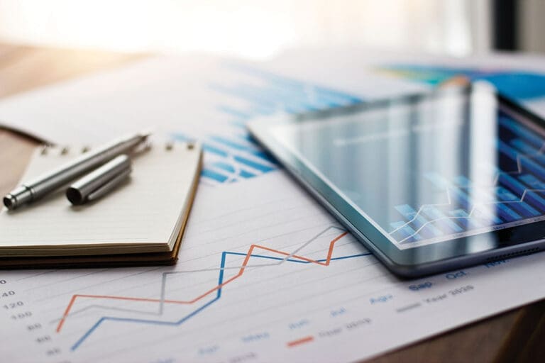 Business Document Report On Paper And Tablet With Sales Data And Financial Business Growth Graph On Table Background.