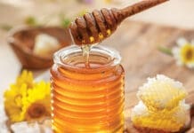Hey Honey Natural Organic Honey In Glass Jar, Honey Dipper And Honeycombs Are Near. Natural Food Background.