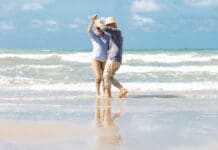 Senior Couple Dancing On Beach Istock 1322107306